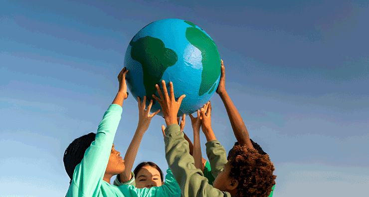 Um grupo de pessoas segurando um grande globo azul e verde